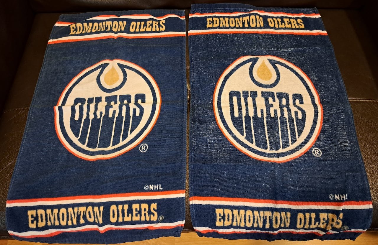 default-345 A pair of blue towels with a logo reading the word "Oilers" and additional text reading Edmonton Oilers.